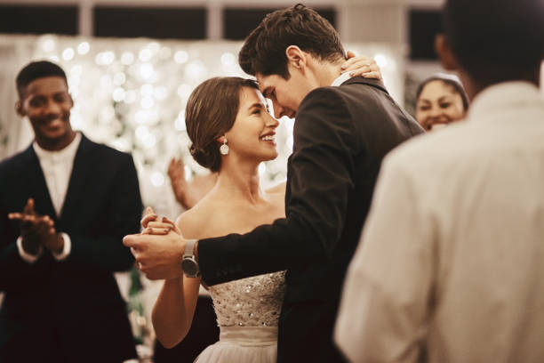 A bride dances with the groom at a wedding.